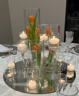 mirror with cylinders and stemmed glass candle holders