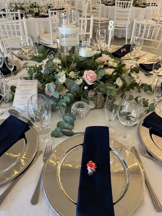ring of foliage and flowers on round tables copy