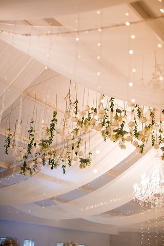 hangin flowers and white voile roof drapes
